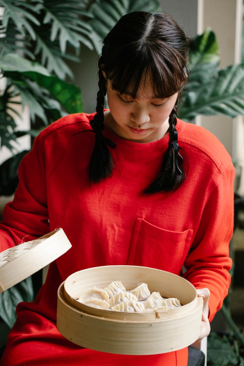 Steamer basket opened to a set of ready dumplings