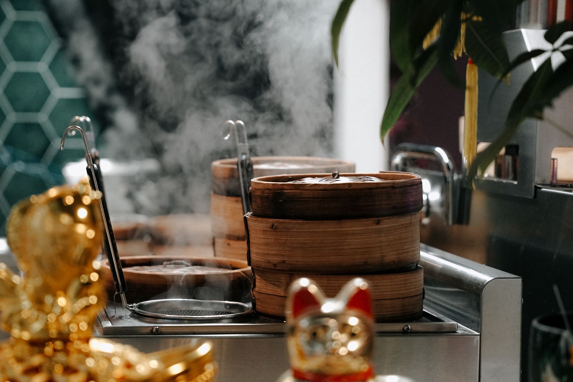 Steam rising from bamboo baskets stacked over a pot.